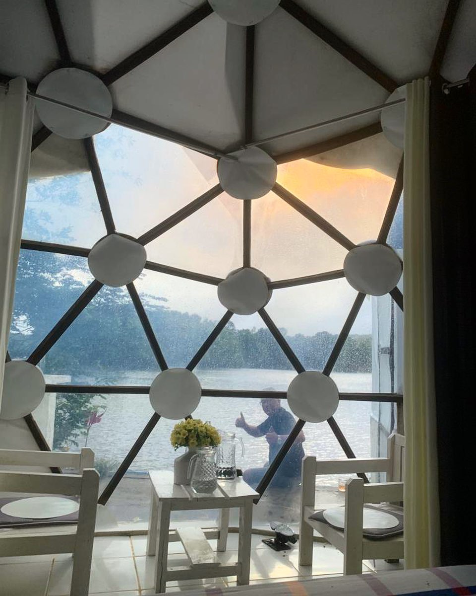 Dome BalaGhee — interior with lake view through the transparent dome panels