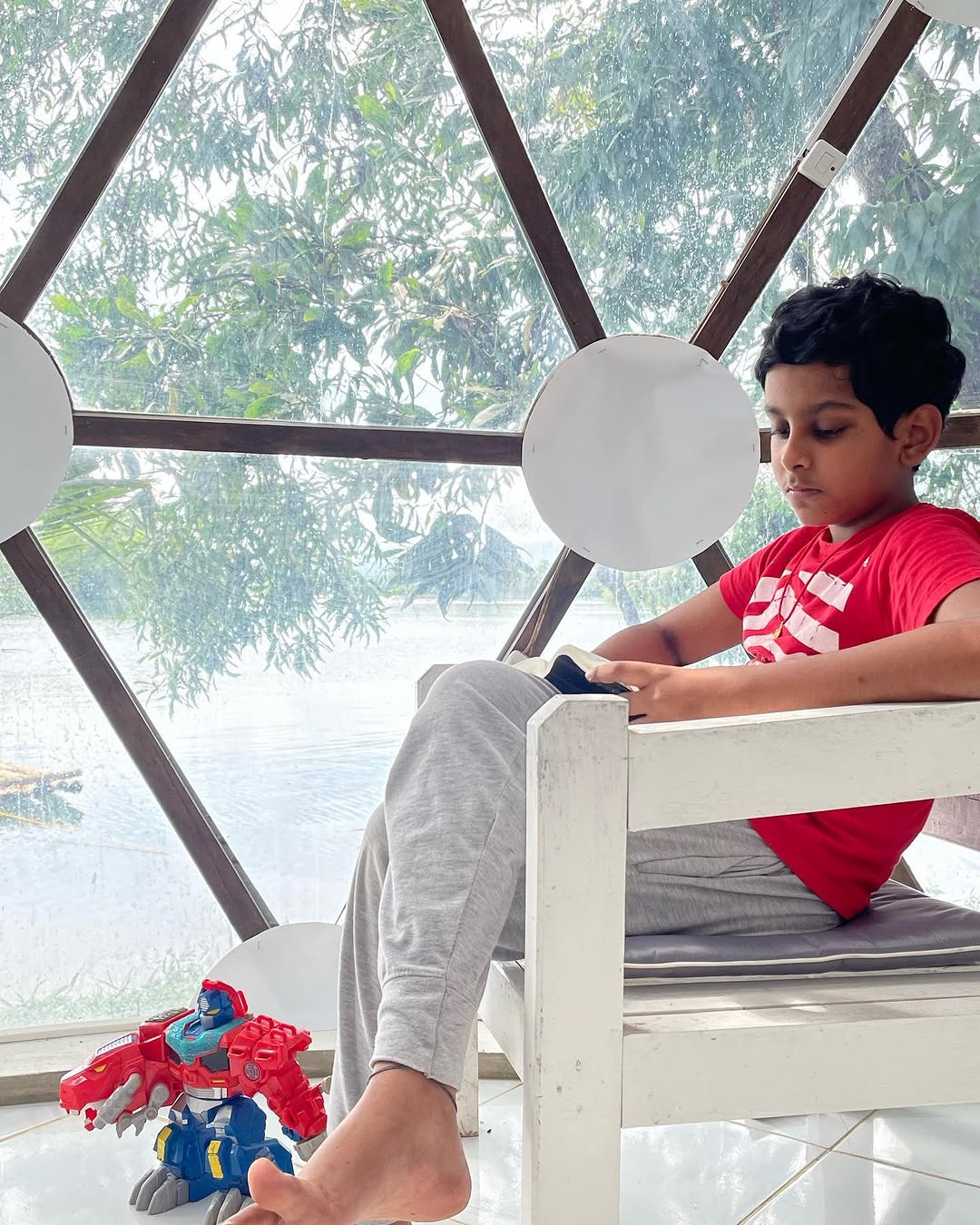 Young guest relaxing inside the dome seating area with lake view